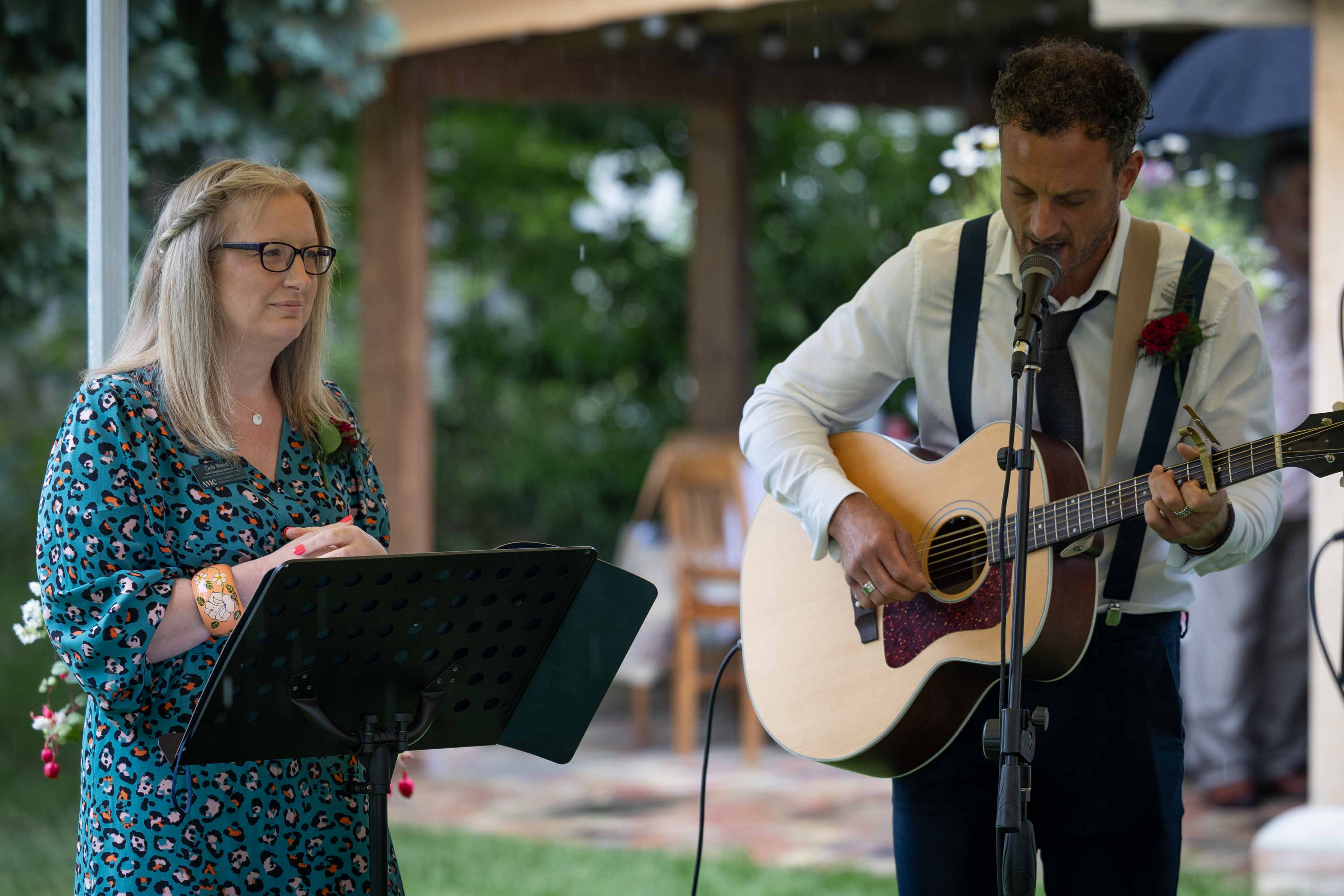 Deb Reed Celebrant Colchester Essex, standing with the singer at Gary and Annette's wedding.