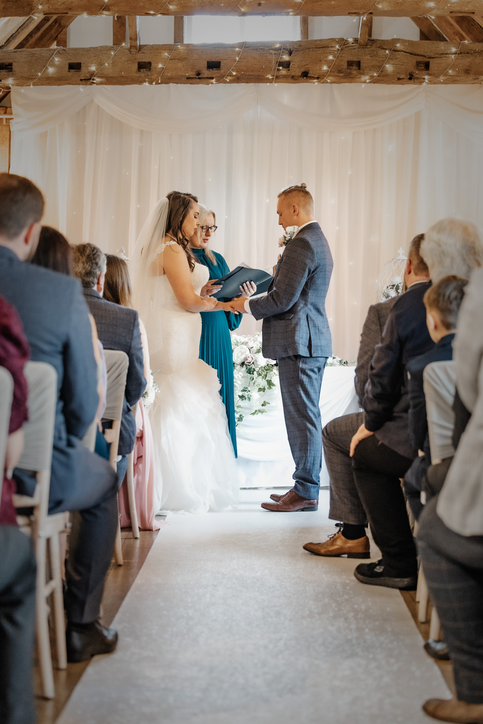 Deb Reed Celebrant Colchester Essex, officiating while the bride and groom hold hands at Rachael and Lukes wedding.