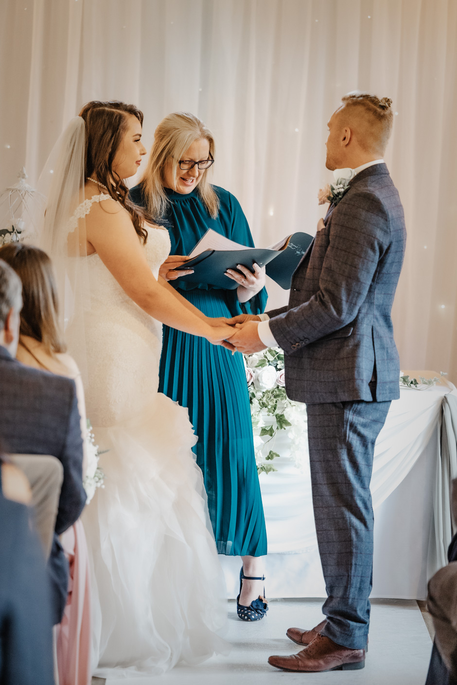 Deb Reed Celebrant Colchester Essex, officiating while the bride and groom hold hands at Rachael and Lukes wedding.