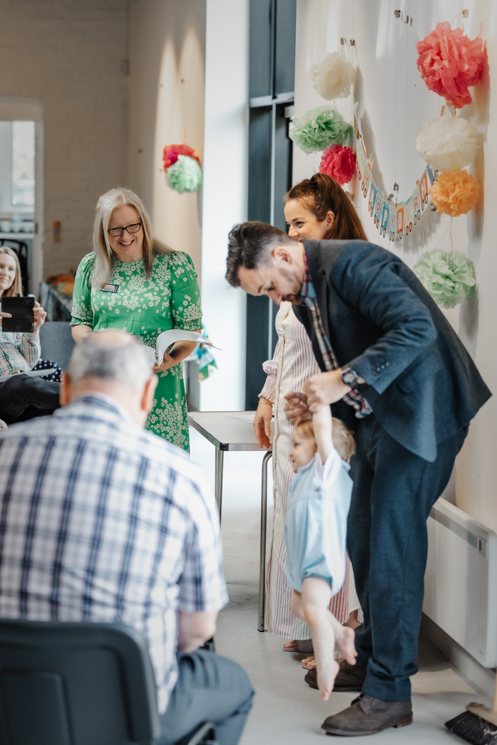 Deb Reed Celebrant Colchester Essex, watching Sebastian play with his Dad at Sebastian's naming ceremony.